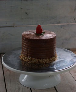 Strawberry and chocolate birthday cake on the stand