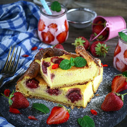 Close-up of cake with strawberries on cutting board