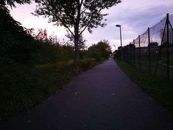 Road amidst trees against sky