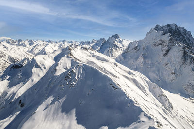 Snowy slope of mountains under clear sky