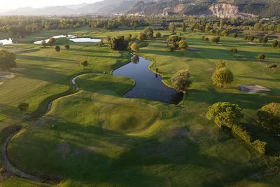 Aerial photographic documentation of a golf course taken at sunset