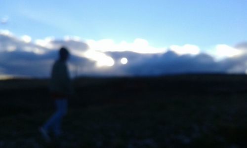 Silhouette of people standing on landscape