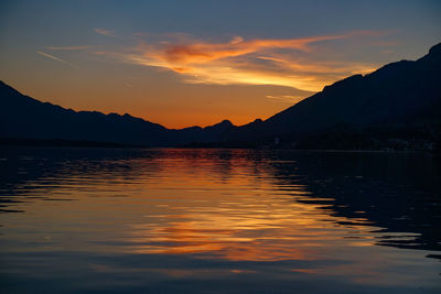 Scenic view of lake against romantic sky at sunset