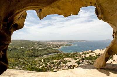 Scenic view of sea and mountains against sky