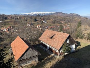 Aerial view of houses and mountains against sky