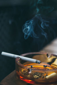 Close-up of cigarette in ashtray