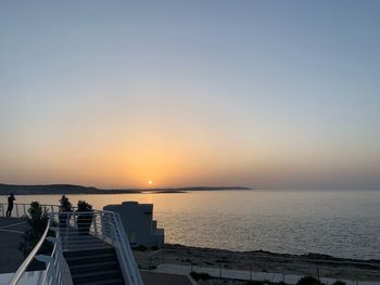 Scenic view of sea against clear sky during sunset