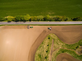 High angle view of road amidst trees on field