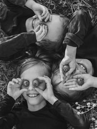 Portrait of three kids, holding tomatoes 