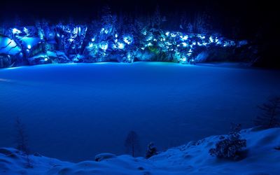 Scenic view of snow covered land at night