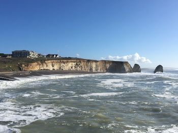 Scenic view of sea against clear blue sky