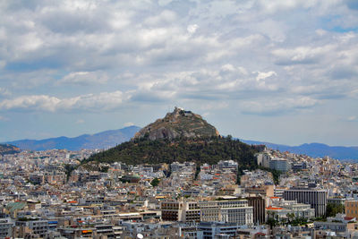 Athens aerial view over the city districts and lykavitos hill, greece