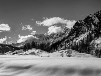 Scenic view of snow covered mountains against sky