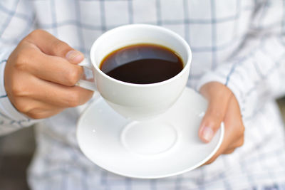 Woman holding coffee cup