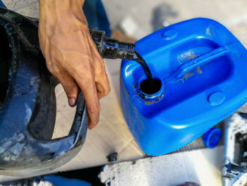 High angle view of man working in blue container