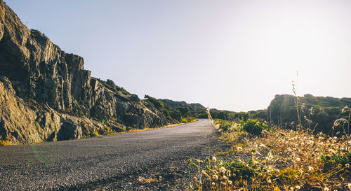 Surface level of road against clear sky