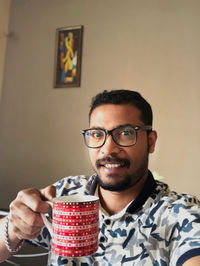 Portrait of young man drinking glasses