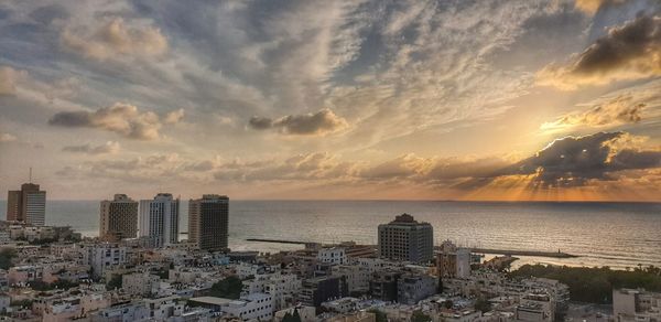 High angle view of buildings by sea against sky