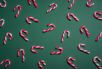 Candy canes on green background