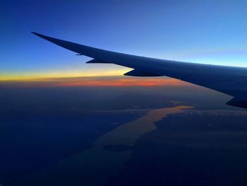 Cropped image of airplane flying over landscape