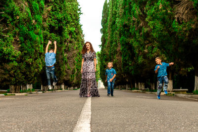 Rear view of people against trees