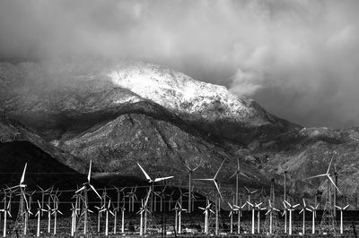 Wind turbines against mountains