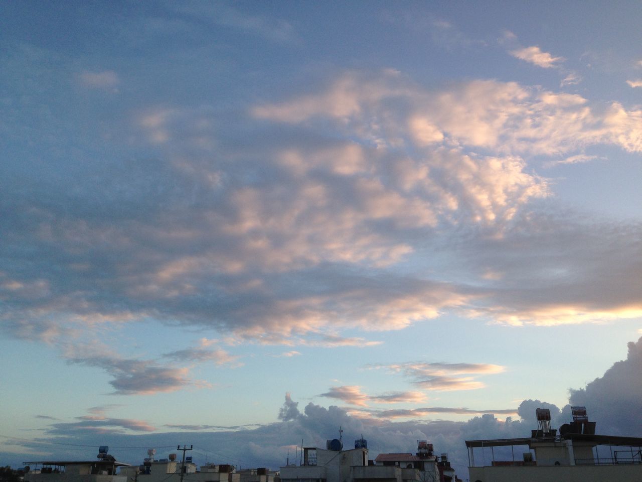 sky, sunset, cloud - sky, architecture, building exterior, built structure, sea, silhouette, cloud, scenics, beauty in nature, city, nature, cloudy, incidental people, outdoors, sunlight, beach, water, tranquil scene