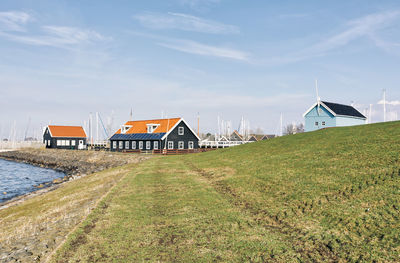 Houses on field against sky