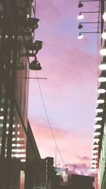 Low angle view of illuminated cables against sky during sunset