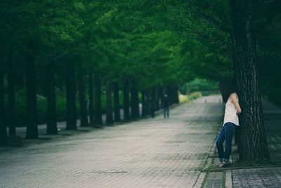 Woman standing by tree at park