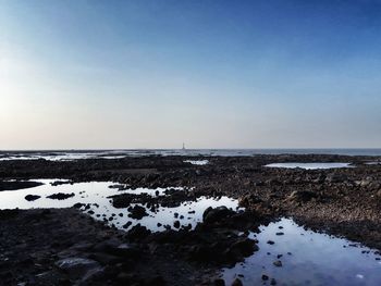 Scenic view of sea against clear blue sky