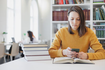 Young woman using laptop at table