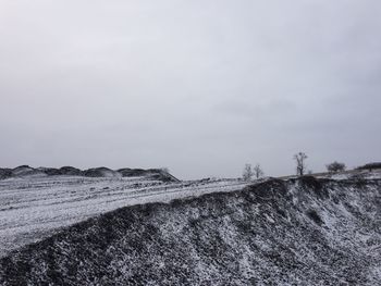 Scenic view of snowy field against sky