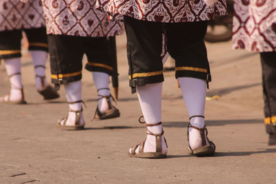 Low section of people walking on street