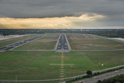 High angle view of the now-closed berlin-tegel airport, runway 26r against sky