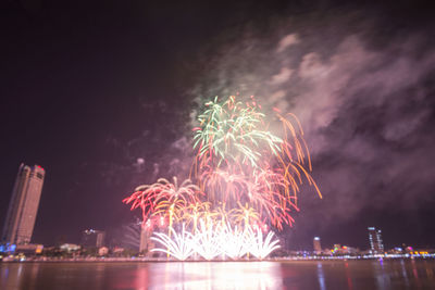 Low angle view of firework display at night