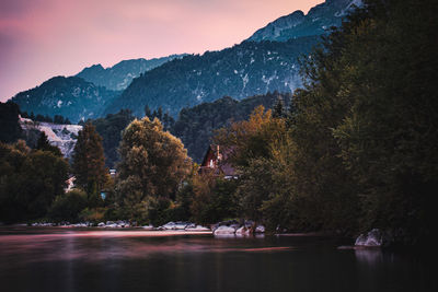 Scenic view of lake by trees against sky