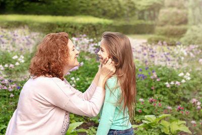 Mom takes care of her daughter on a walk in the park. mental health.