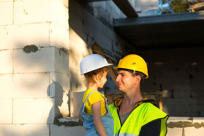 Father with daughter at construction site