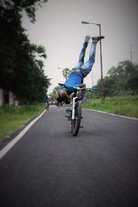 Man riding bicycle on road