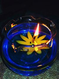 High angle view of illuminated candles on glass