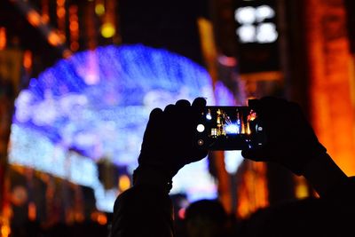 Close-up of man photographing with mobile phone