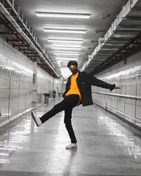 Full length of woman standing in tunnel