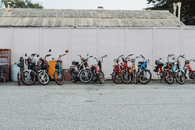 Motor scooter parked on street against building