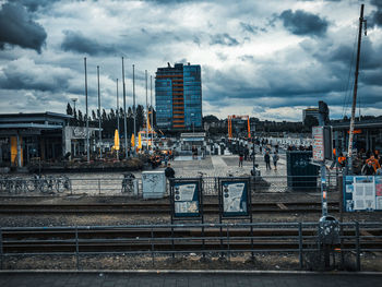 Railroad tracks by buildings against sky in city