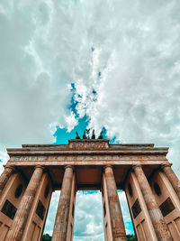 Low angle view of historical building against cloudy sky