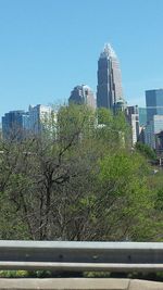 Buildings in city against clear sky