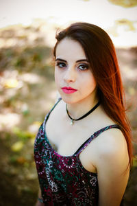 Portrait of beautiful woman standing on field