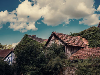 View of old houses in village against sky