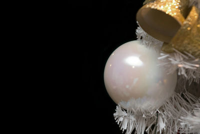 Close-up of illuminated lighting equipment against black background